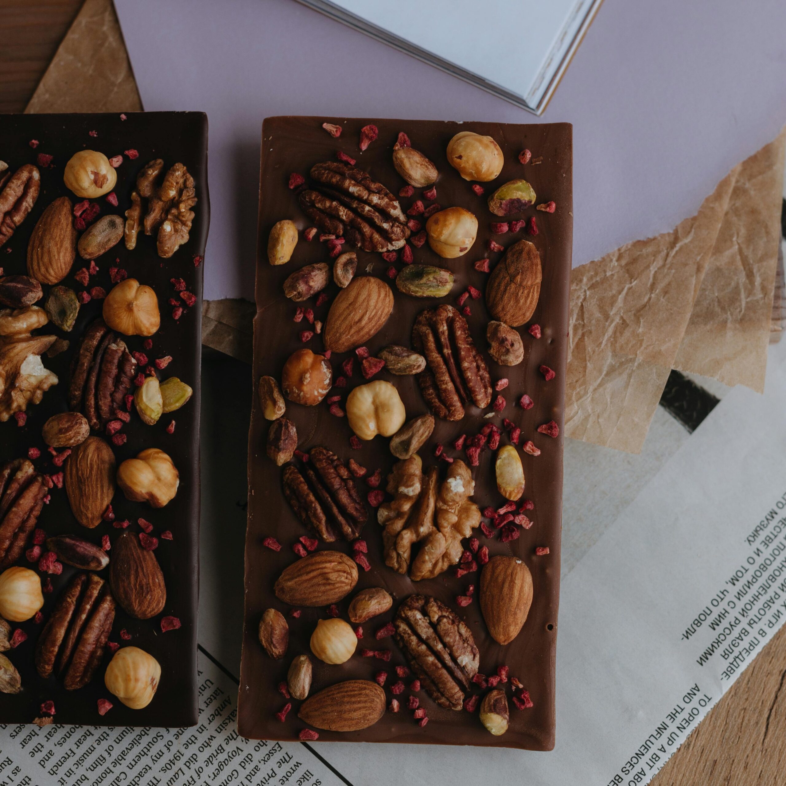 Delicious homemade chocolate bars topped with assorted nuts and berries for a perfect dessert treat.